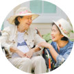 senior woman on a wheelchair with another woman sitting beside her