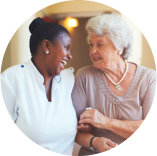 caregiver smiling with a senior woman